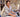 Woman working at a table with fabric in an office setting