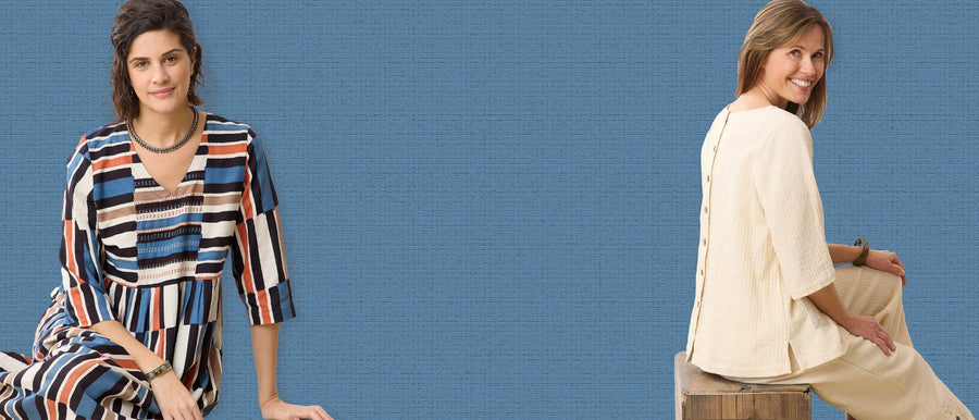 Two women posing against a blue background, one in a striped dress and the other in a beige outfit.