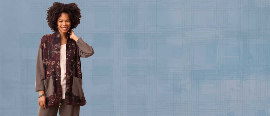 Woman wearing a patterned outfit against a blue background