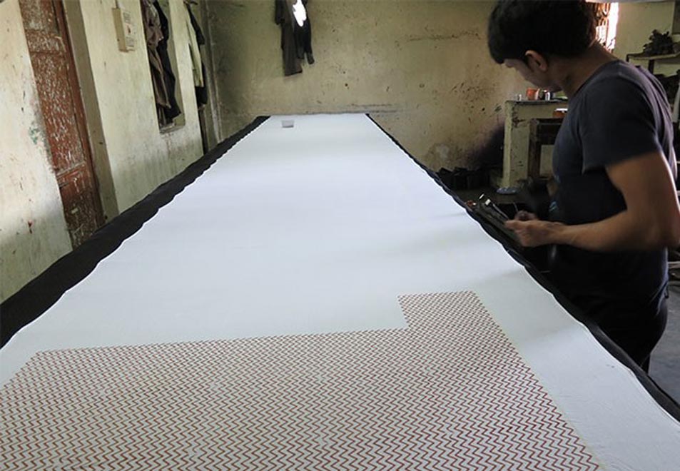 Fabric stretched on table, and stamped