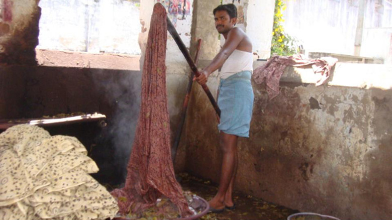 Kalamkari fabric being dyed