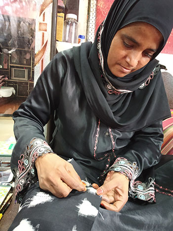 An artisan at home doing embroidery